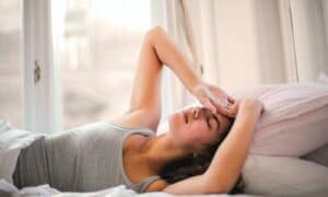 woman waking up in pain